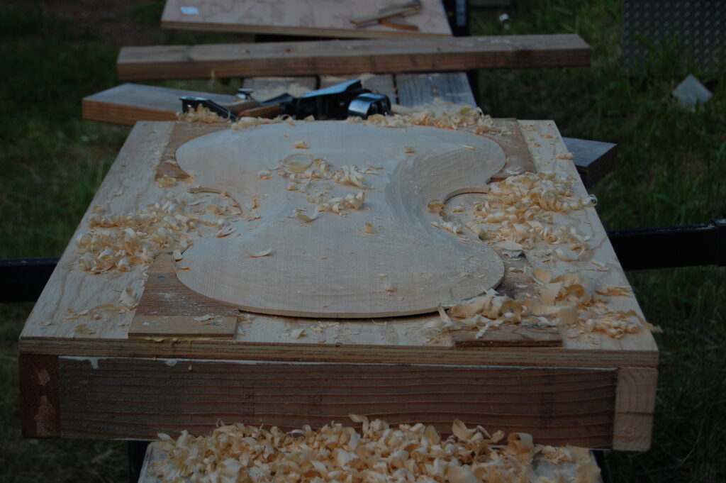 partially carved front plate arching of cello